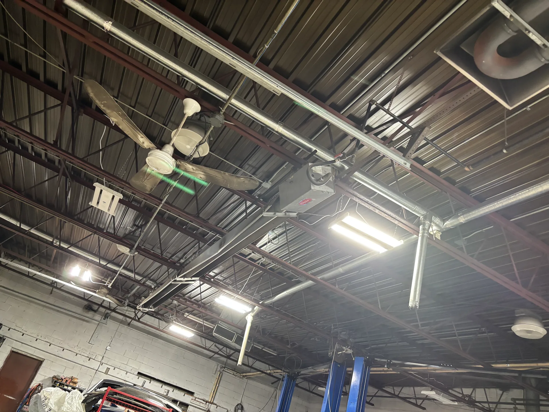 Round and rectangular ductwork suspended in a commercial ceiling