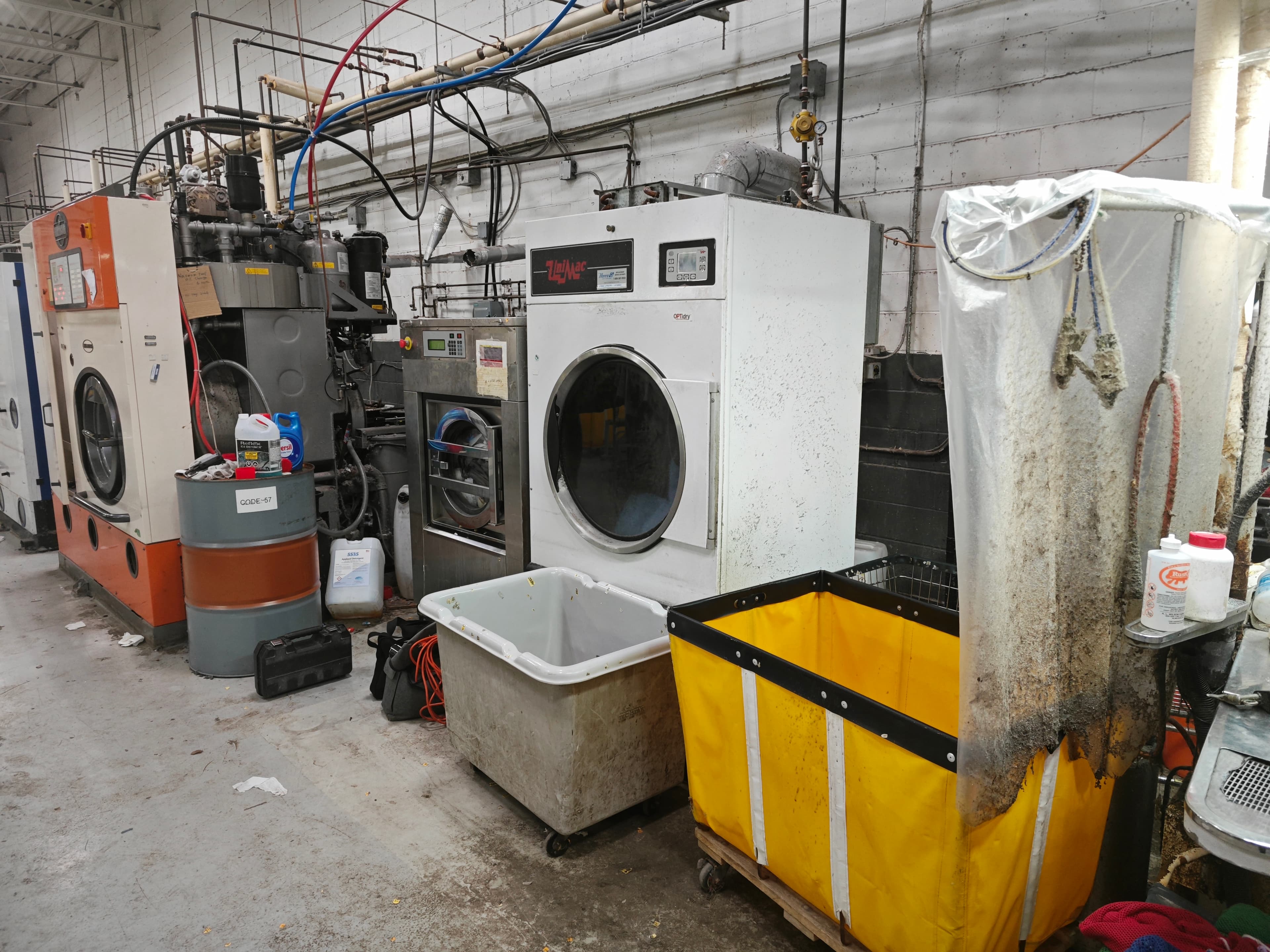 Industrial laundry room with washing machines and laundry carts